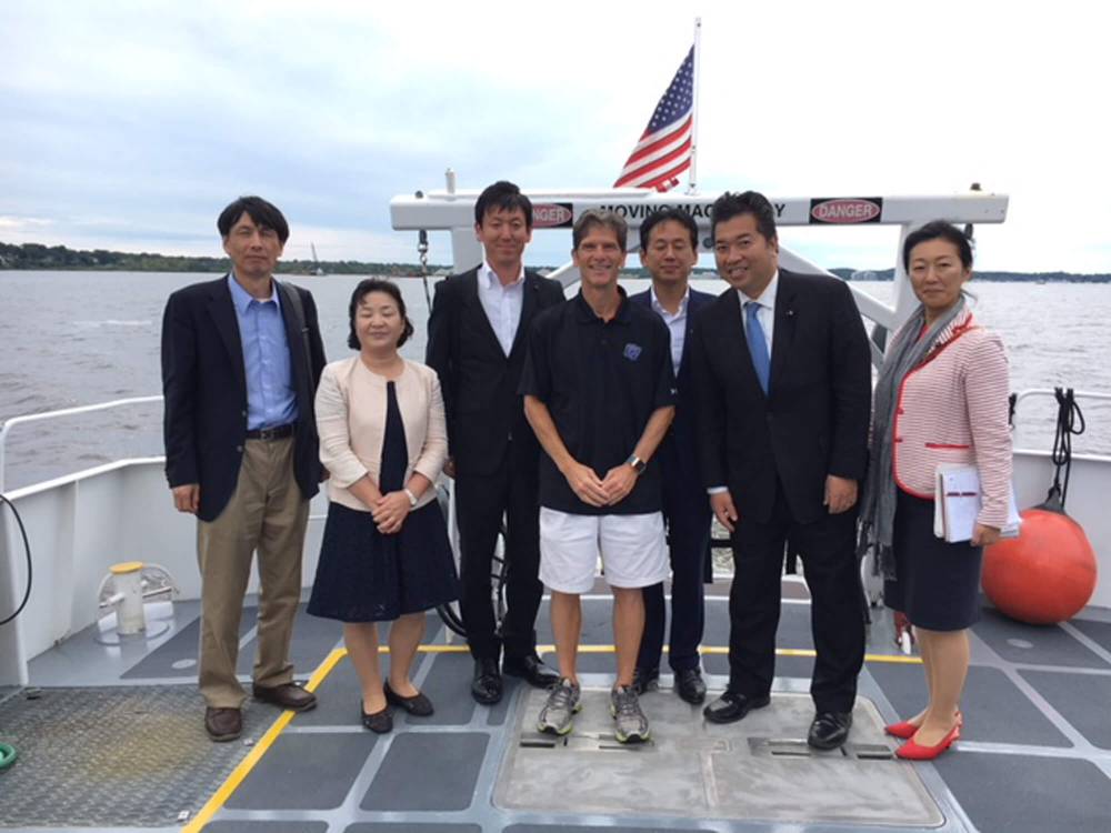 Director Al Steinman poses on an AWRI vessel with the delegation from Japan